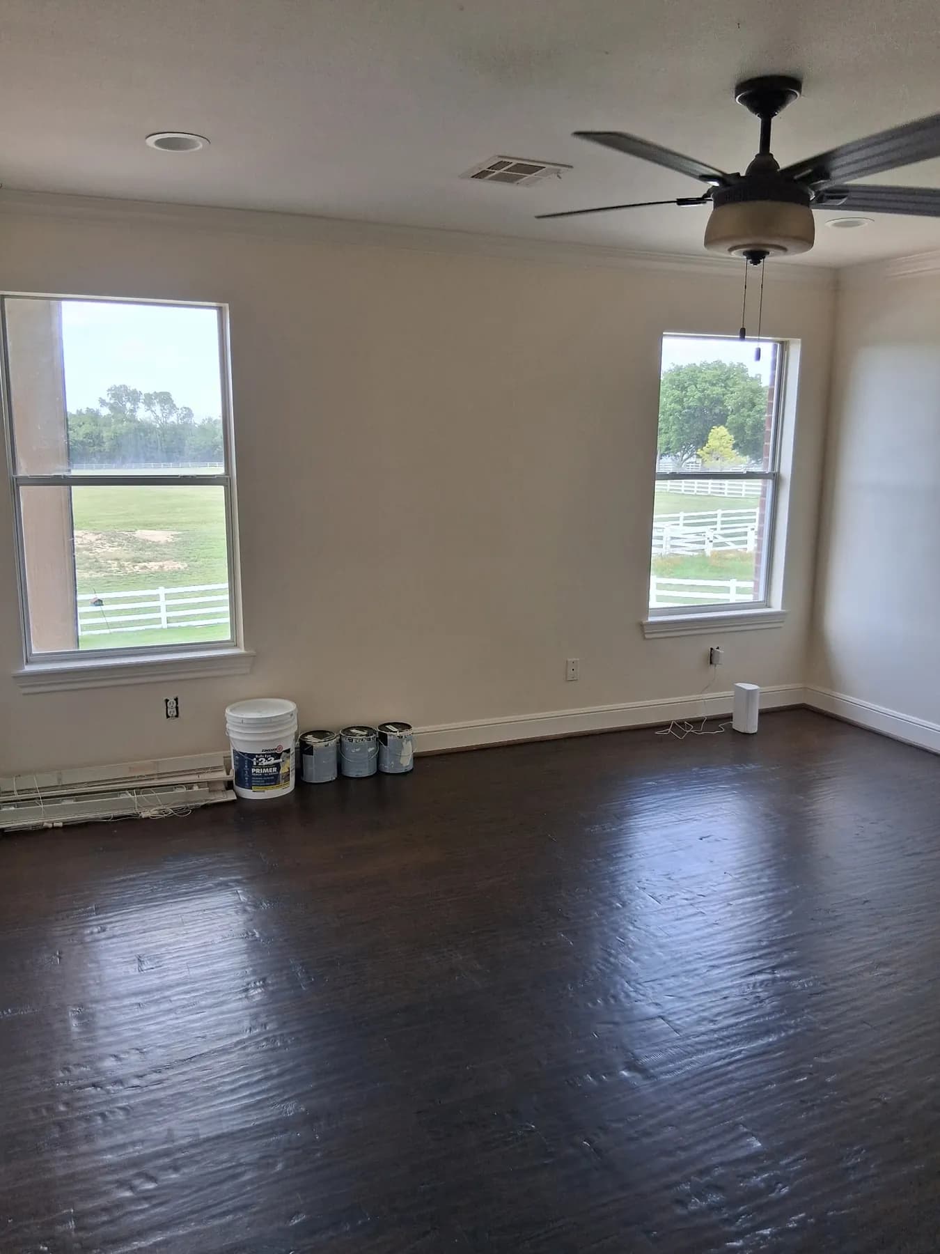 Interior room with painted walls and dark wood flooring during project work
